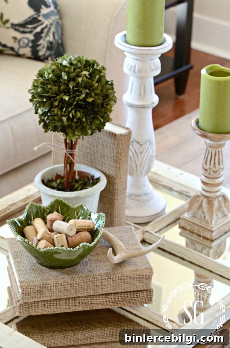 coffee table with trinkets, a plant and books wrapped in burlap