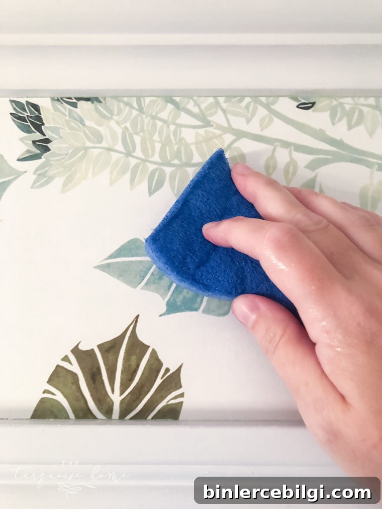 adhere wallpaper with damp sponge