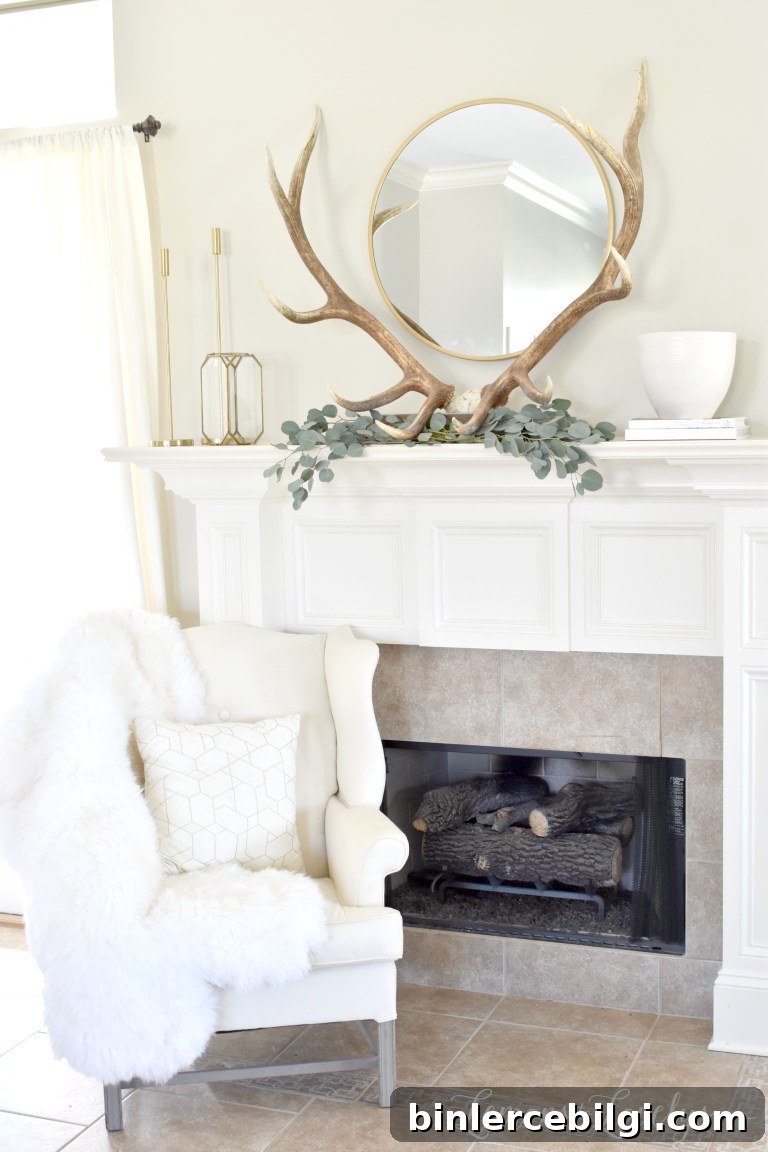 spring mantel decor with antlers, eucalyptus leaves, and a circle mirror