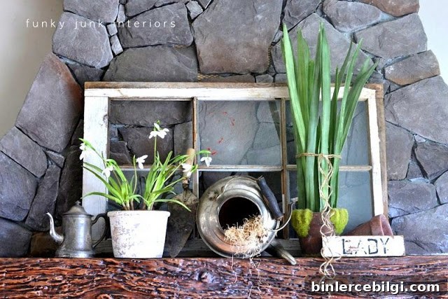 a collection of antique pieces mixed with fresh greenery for springtime mantel decor