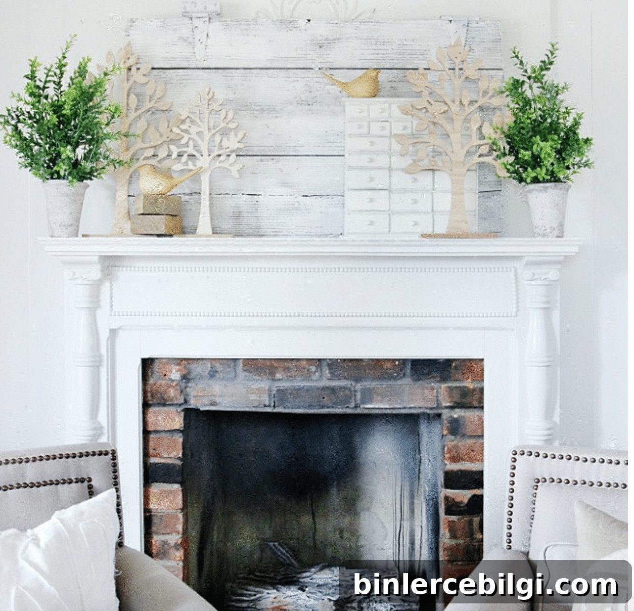 spring mantel decor with tree cut outs, greenery, and bird figurines 