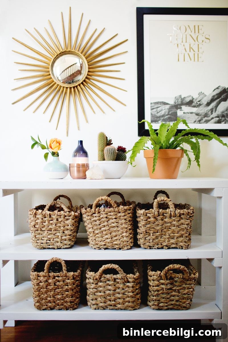 15 Clever Entryway Storage Ideas for Small Spaces 7 Styled entryway with shelving unit, baskets and plants.