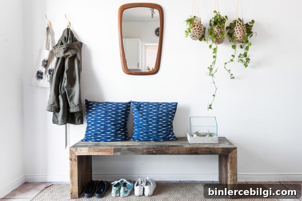 15 Clever Entryway Storage Ideas for Small Spaces 11 Beautifully styled entryway with bench and hooks for hanging jackets and bags.