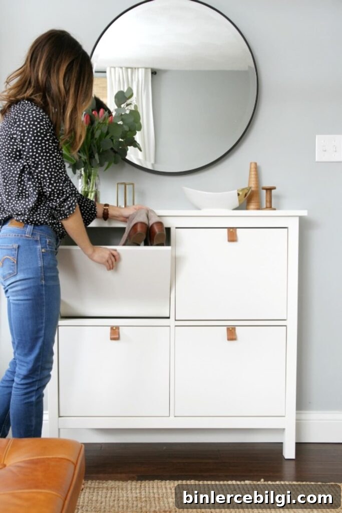 15 Clever Entryway Storage Ideas for Small Spaces 12 IKEA shoe cabinet dressed up with leather pulls and a large round mirror.