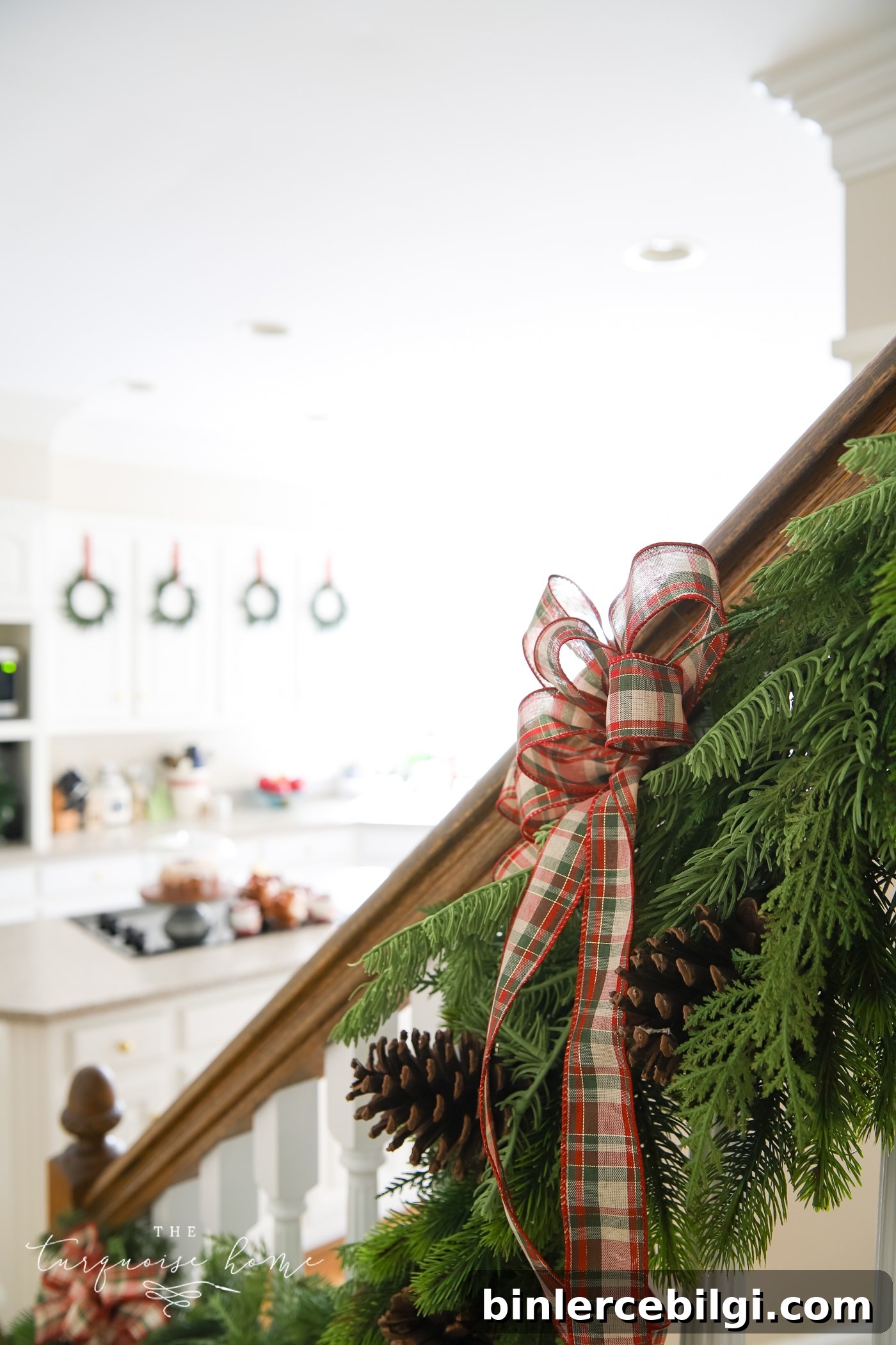 Red Plaid Bow on the Greenery on the Stair Banister