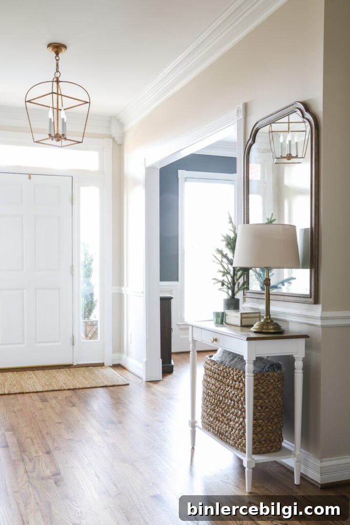 An Organized Foyer with table, lamp and mirror