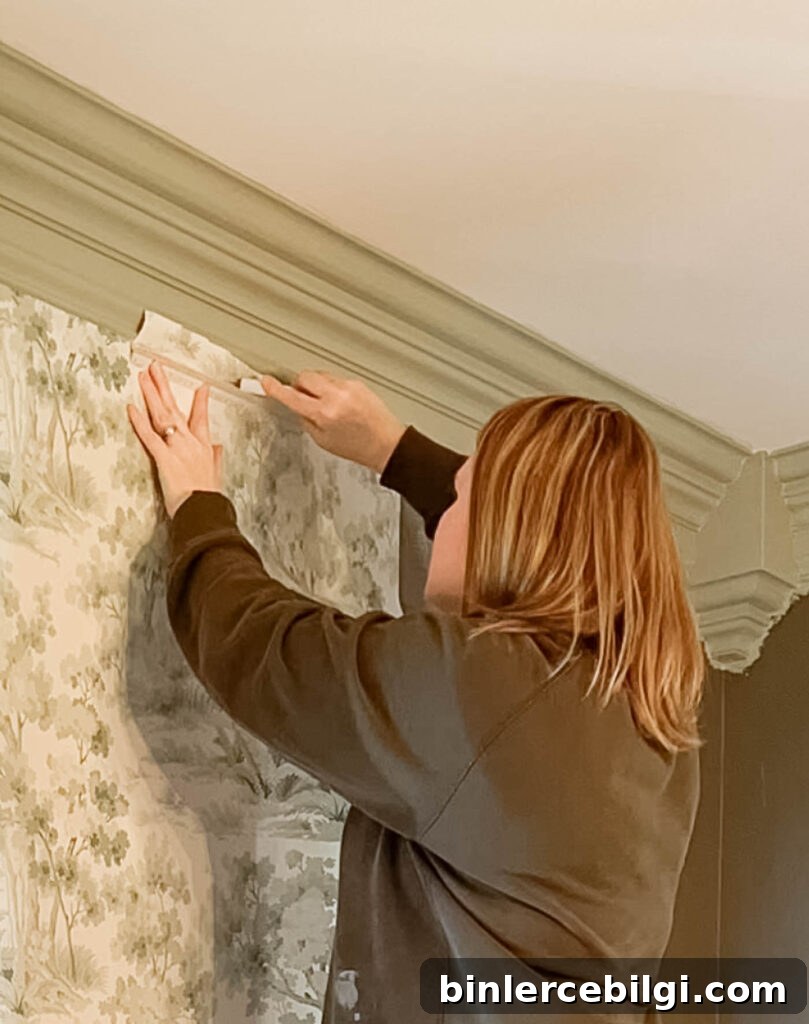 Cut away excess wallpaper