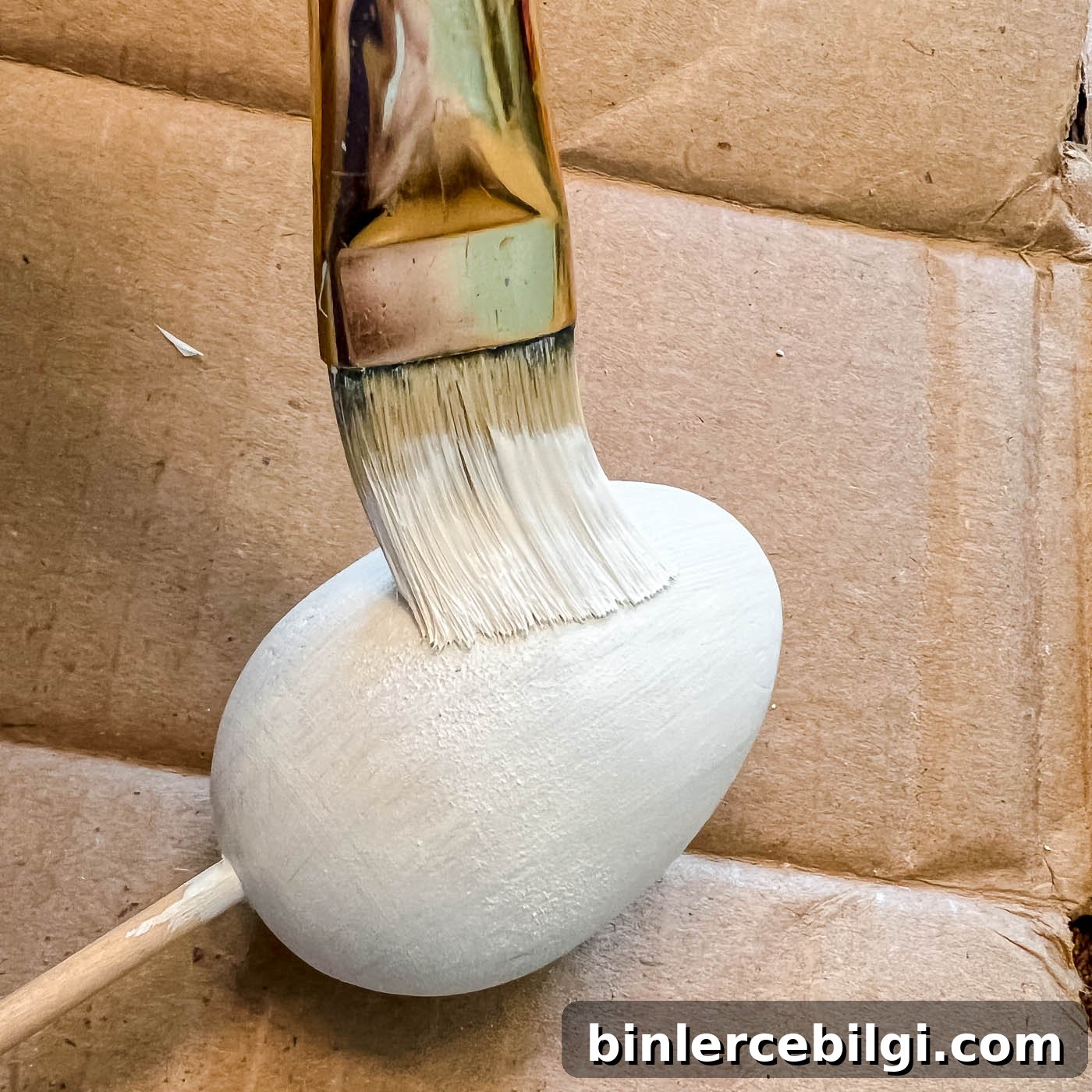 painting a wooden egg white