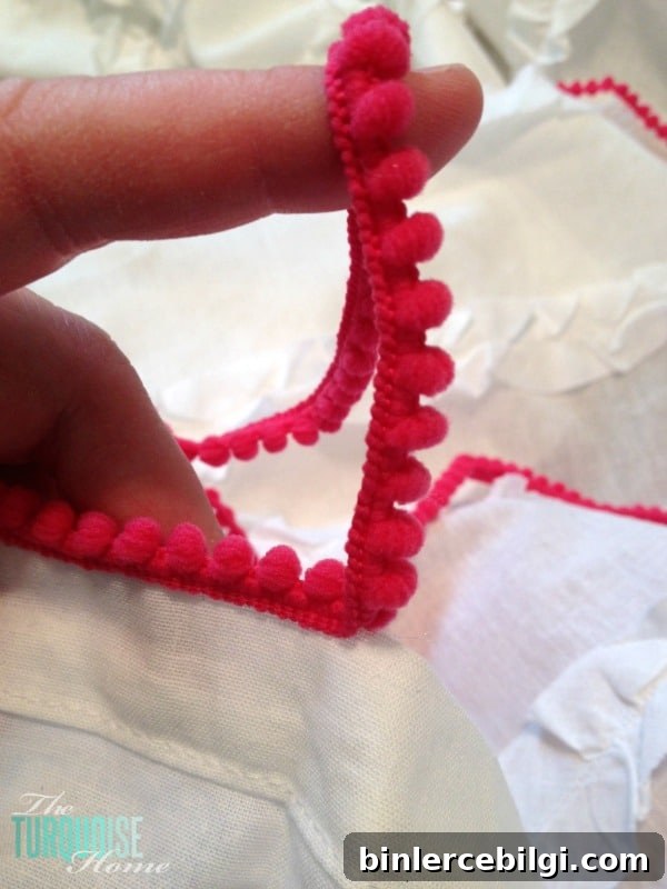 I love the little detail of the pom pom trim. And it's no-sew, my favorite!! Sweet Nursery Curtains with No-Sew Pom Pom Trim | TheTurquoiseHome.com