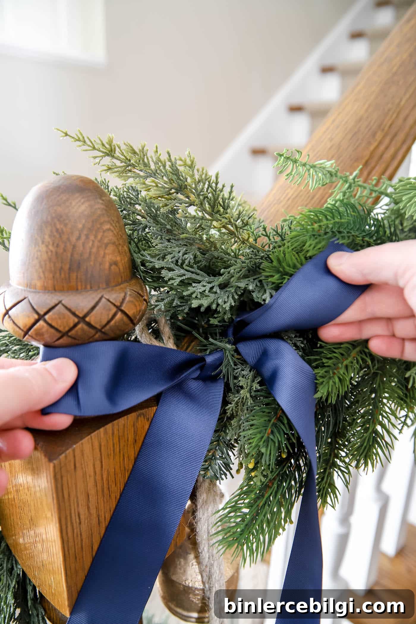 Bow accessories on stairwell garland
