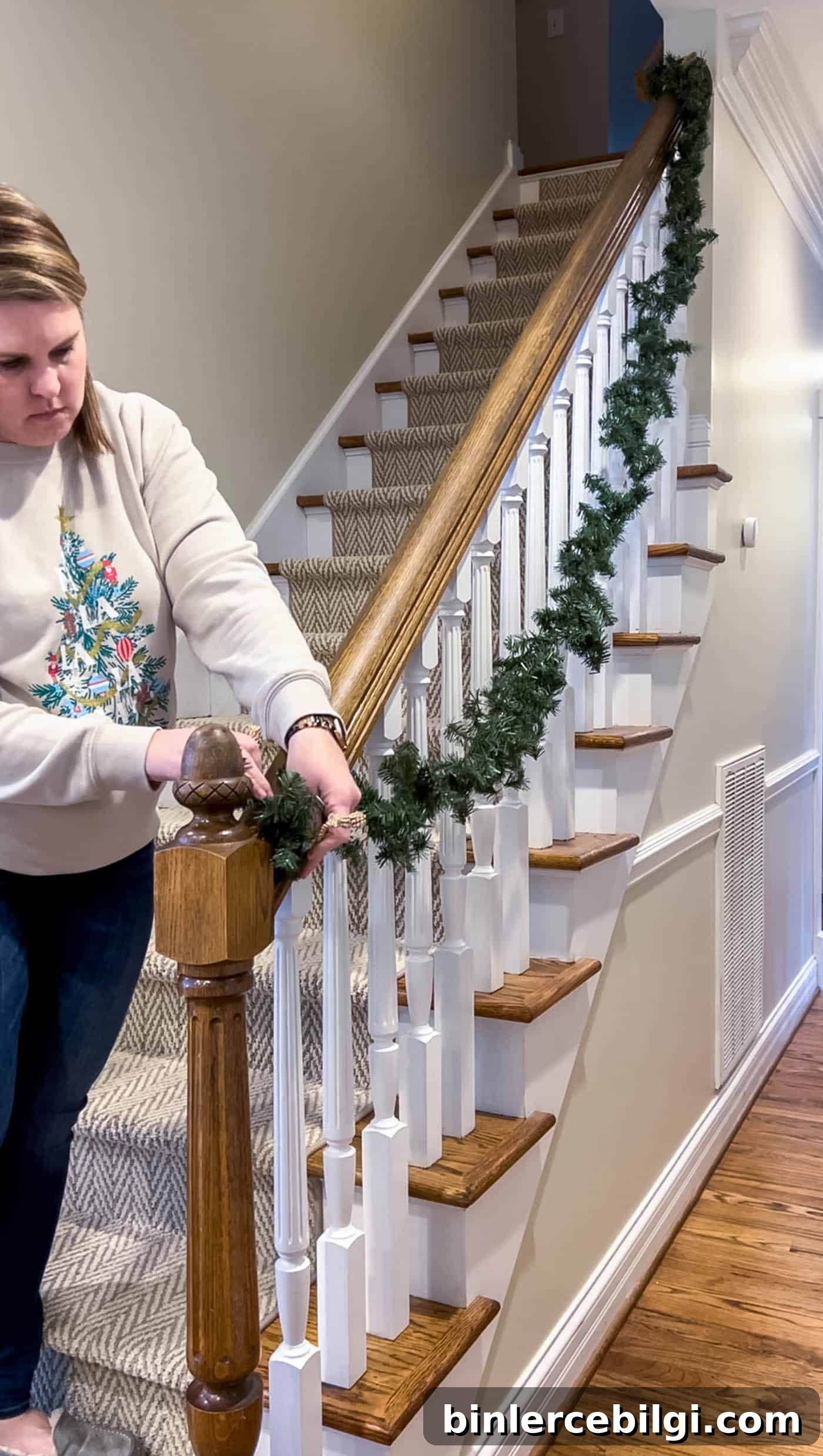 Hang the first garland on the stairs