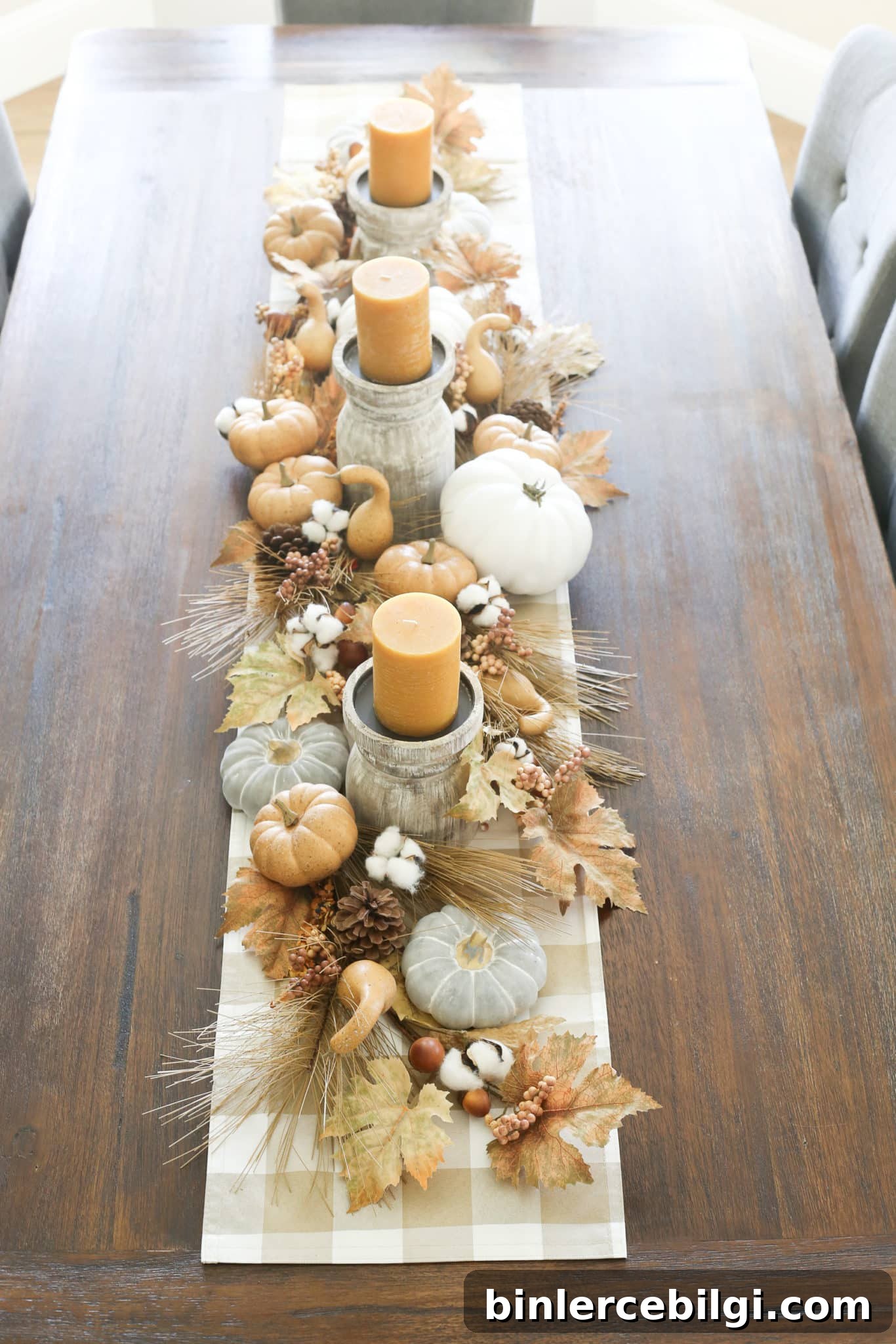 fall tablescape with pumpkins, leaves, and candles.