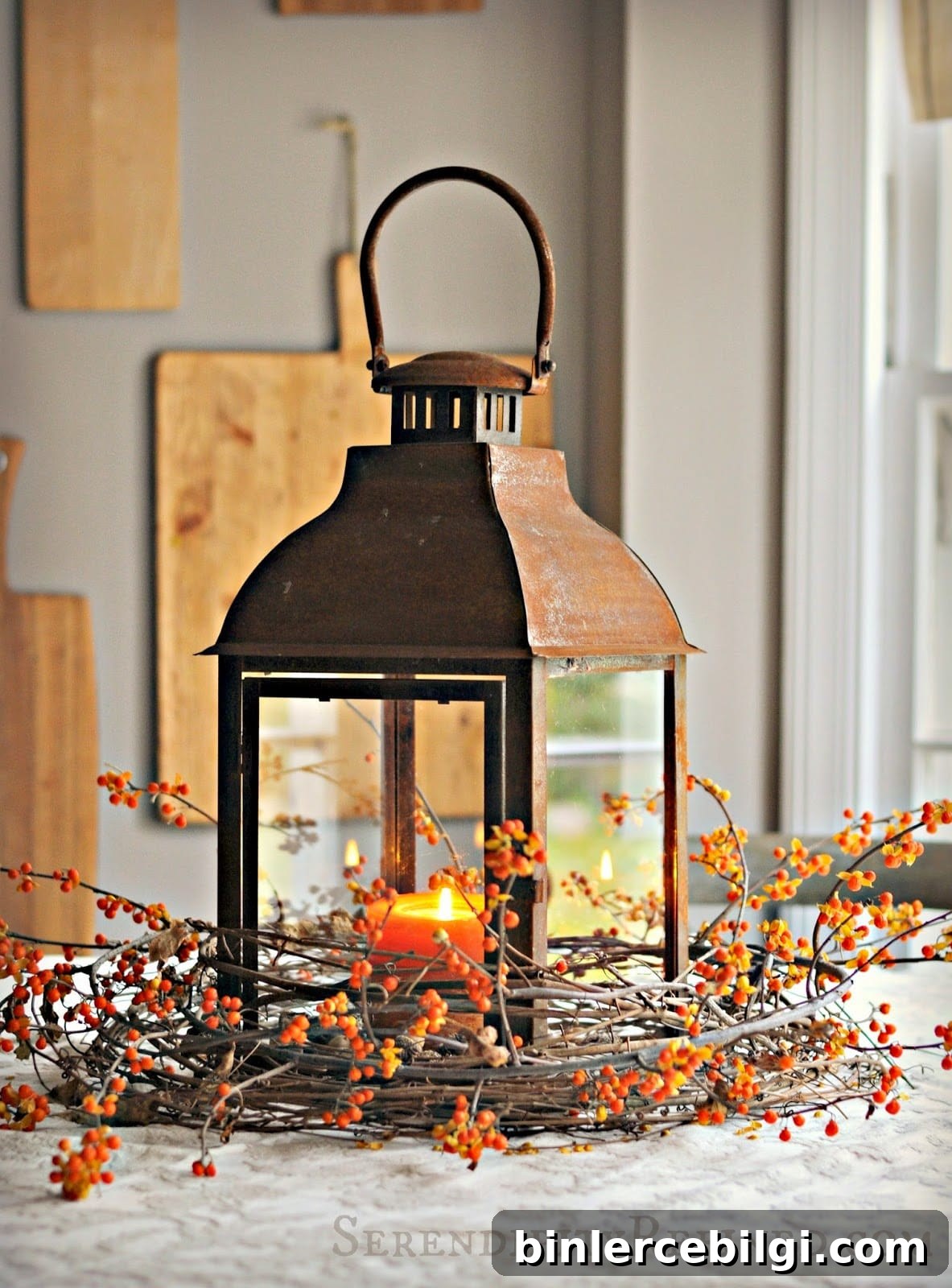 rustic lantern wrapped in grapevine and berry sprig