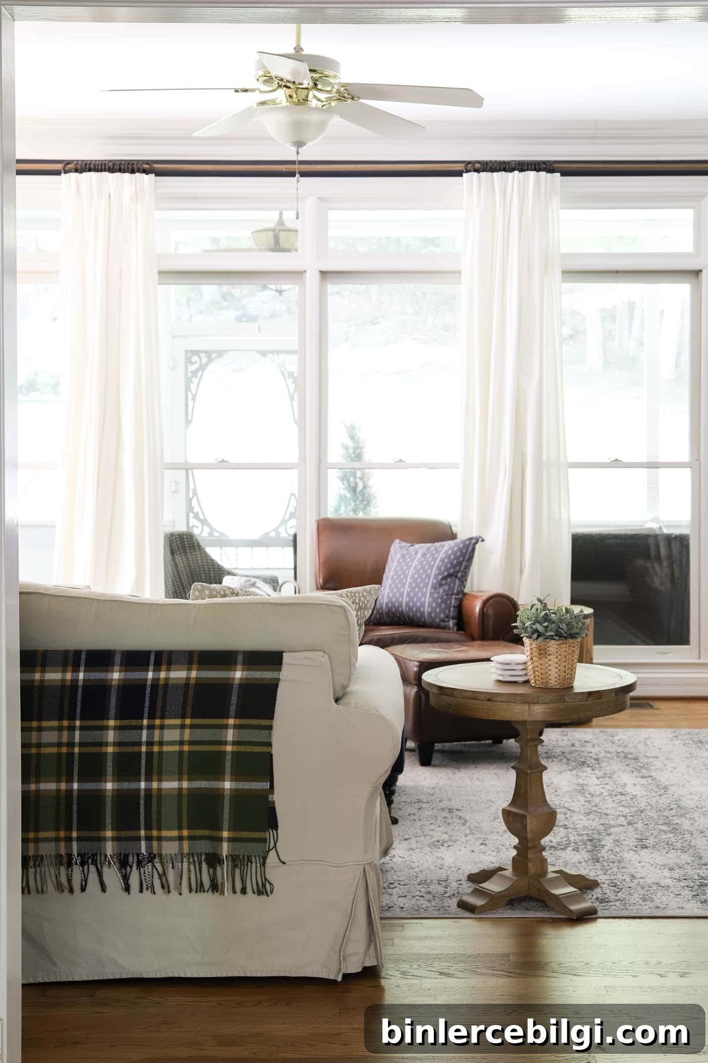 Plaid throw blanket on back of the sofa for fall decor