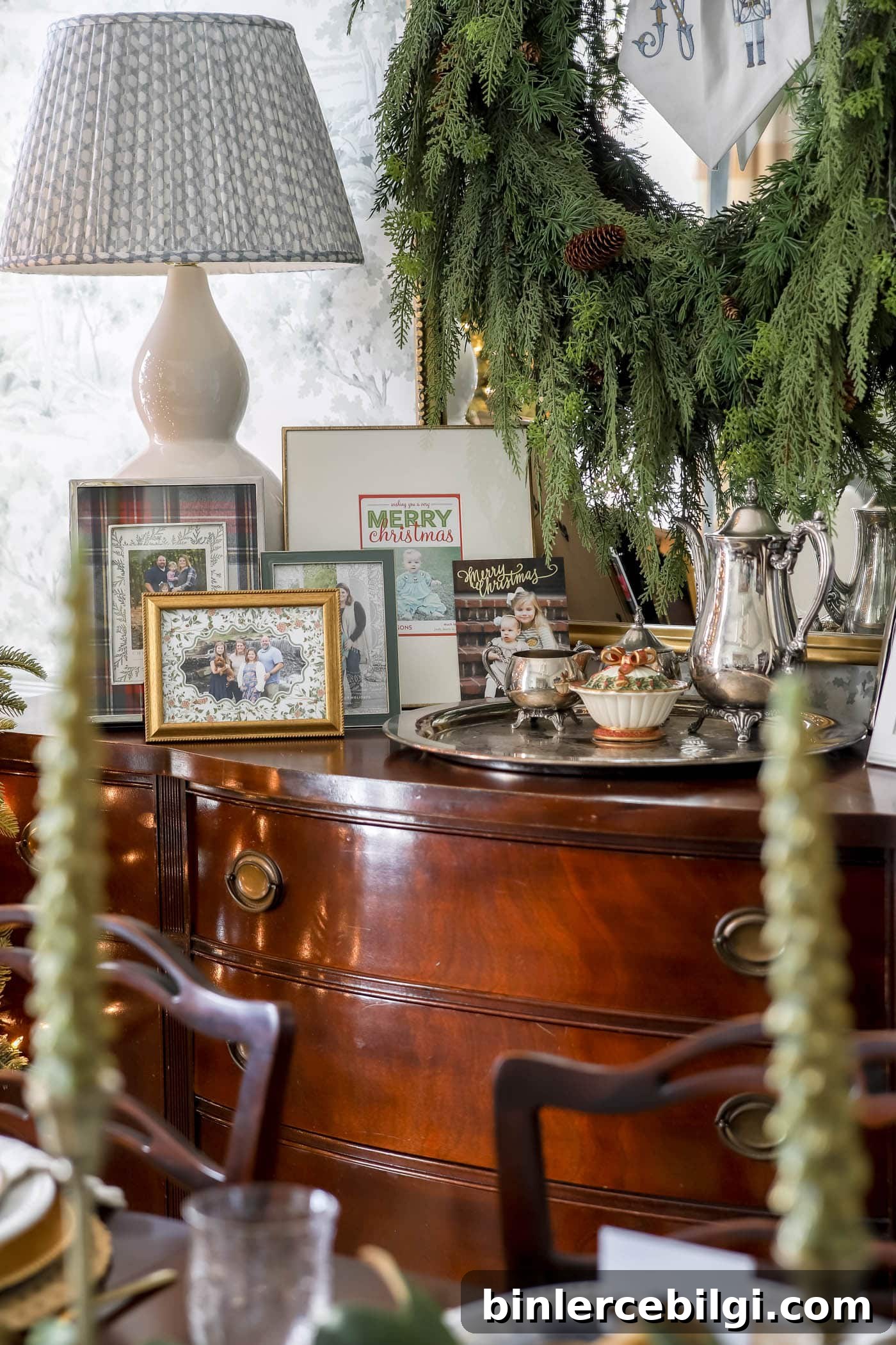 25 Timeless Interior Design Ideas to Last a Lifetime 18 Christmas dining room buffet with framed Christmas cards displayed.