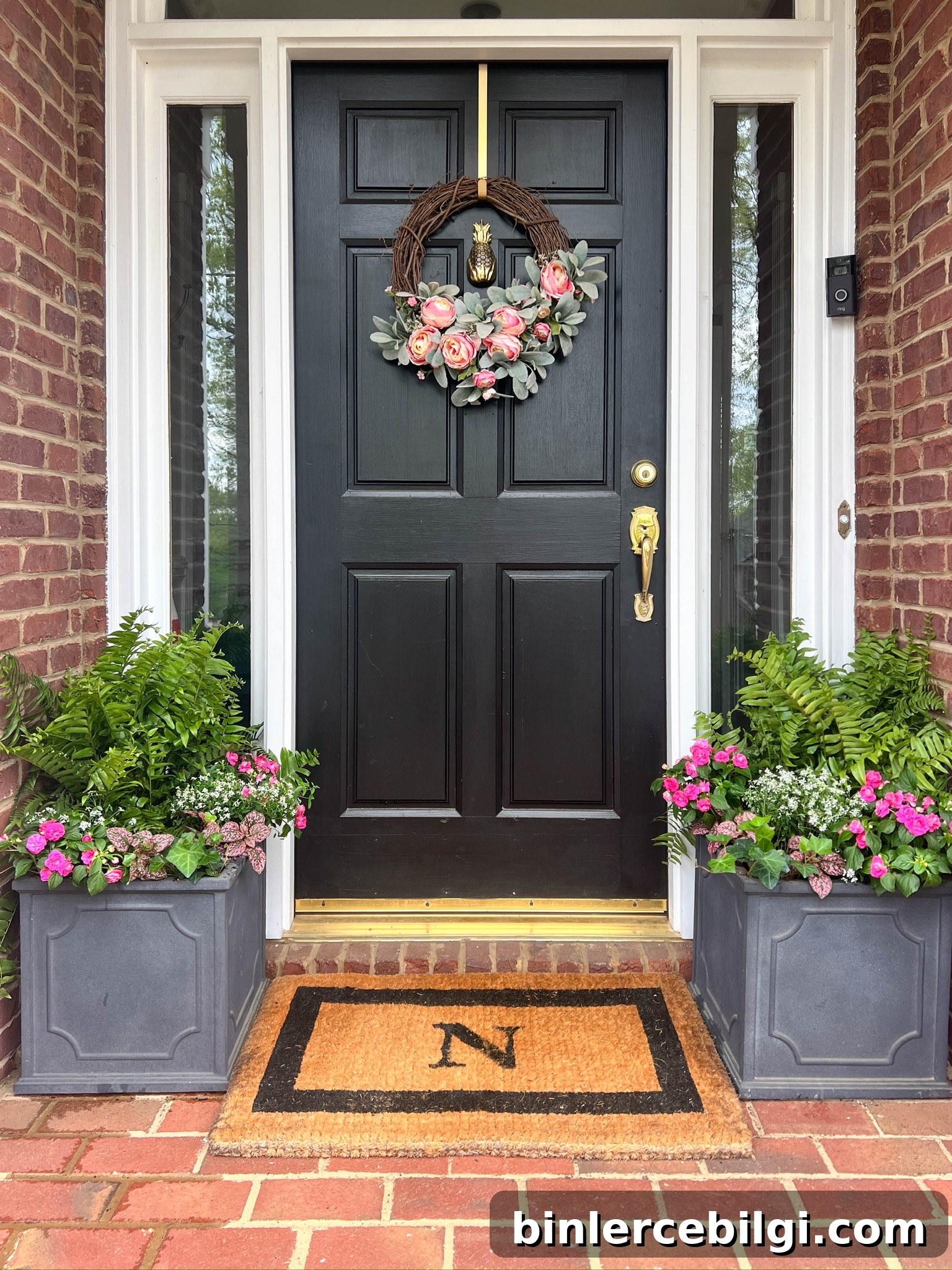 Planters with spring flowers on small front porch
