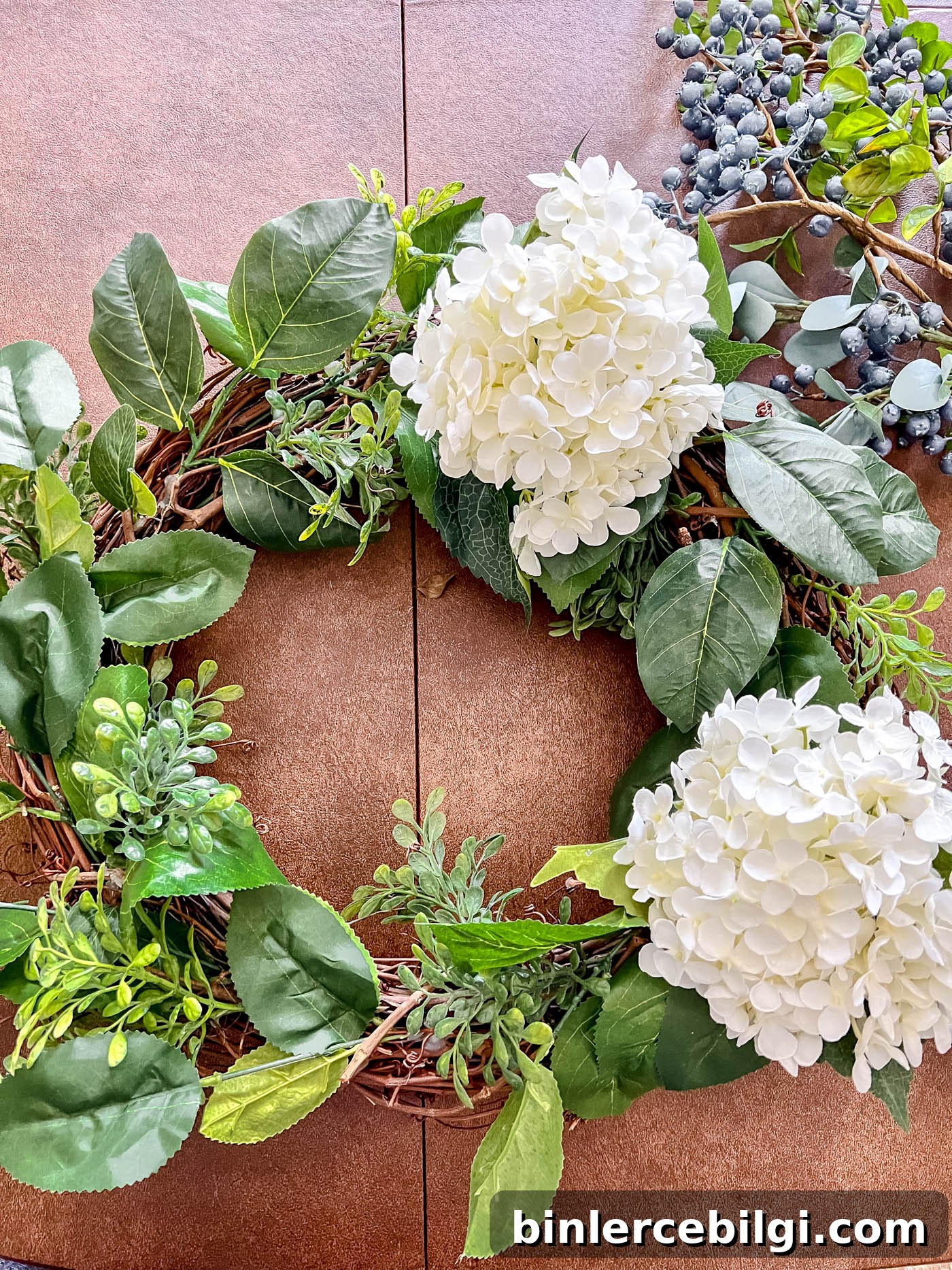 Add hydrangeas to patriotic wreath