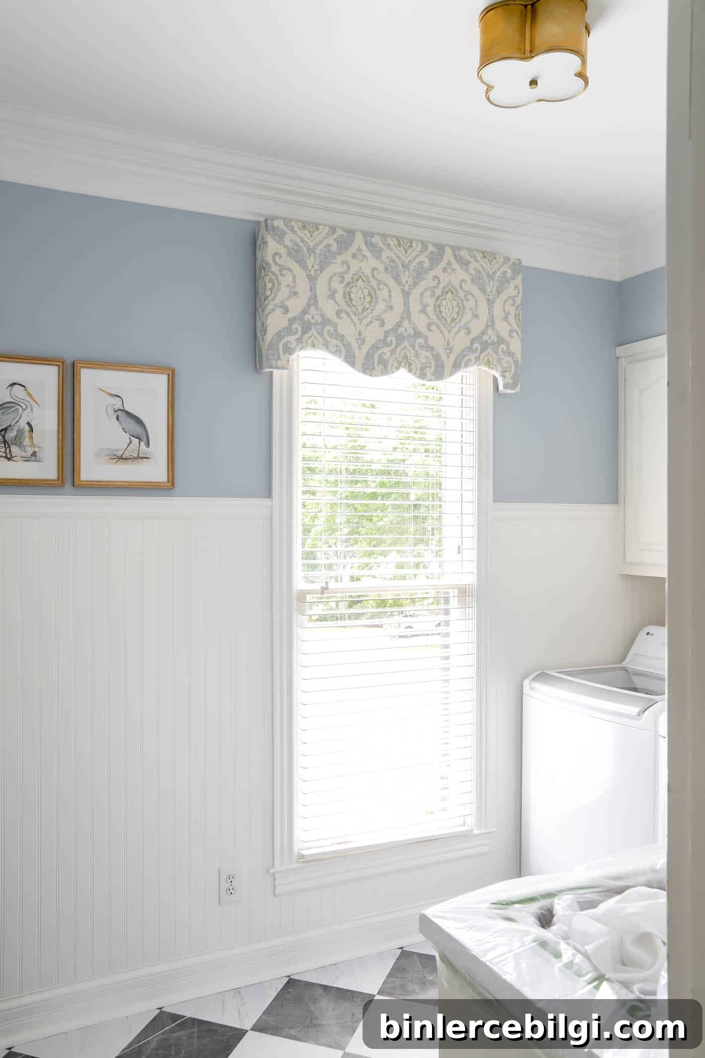 Laundry room with blue walls and white beadboard.