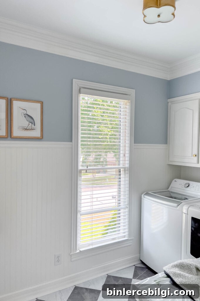 Laundry room with blue walls and white beadboard.
