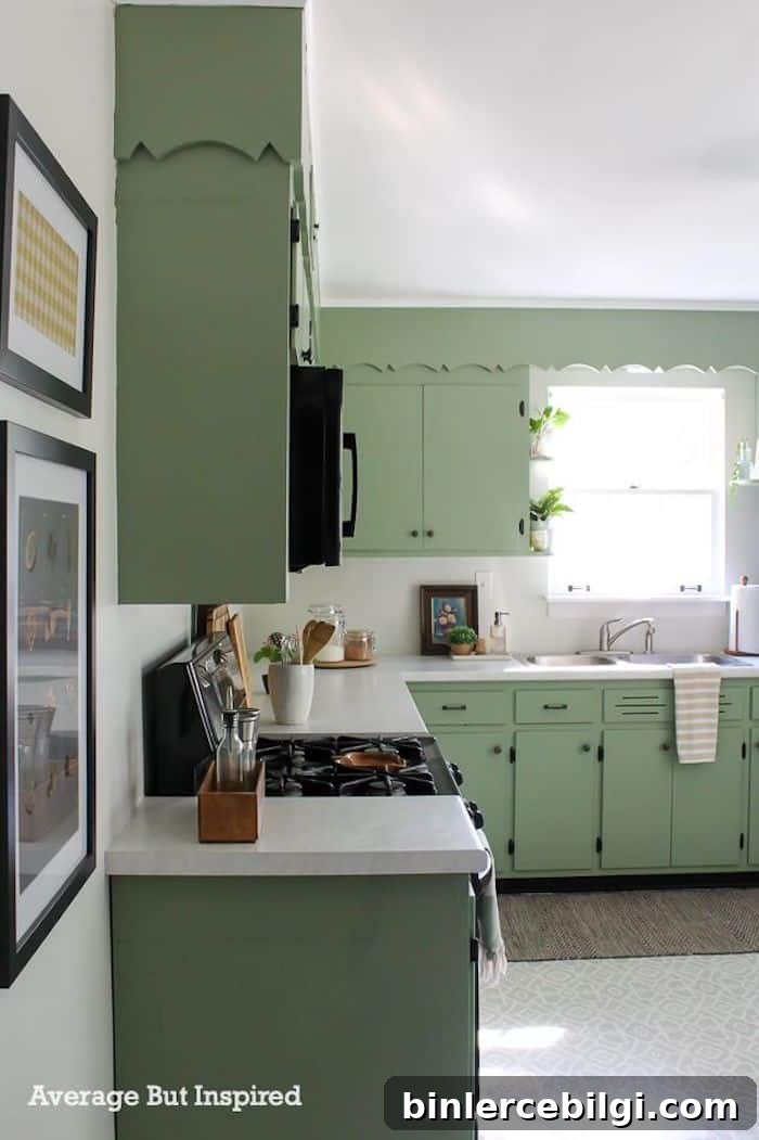 kitchen with white countertops and Behr Hillside Green painted cabinets