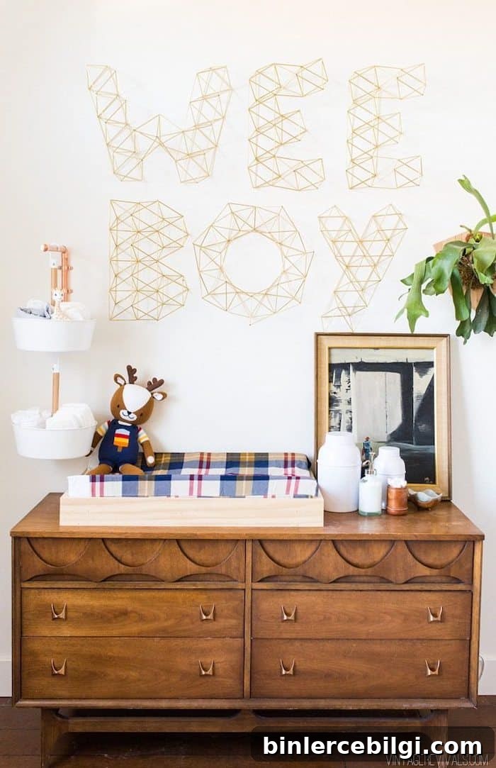 Boy's nursery with Sherwin Williams Alabaster wall color and 'wee boy' wall art over a wood dresser.