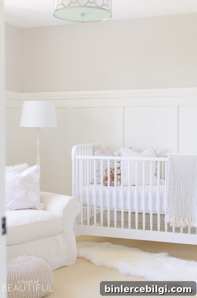 Neutral nursery with Pale Oak walls, white board and batten, white crib, white lamp and white glider rocker.