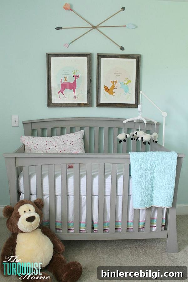 All of the pretty pink and turquoise touches with a woodland theme make a sweet retreat for any little girl. | Baby Girl's Woodland Nursery