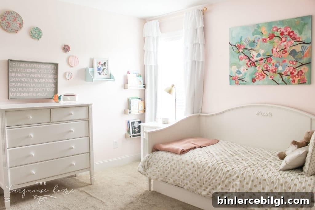 gold, pink and turquoise girls bedroom decor with hoop art and white daybed with white dresser.
