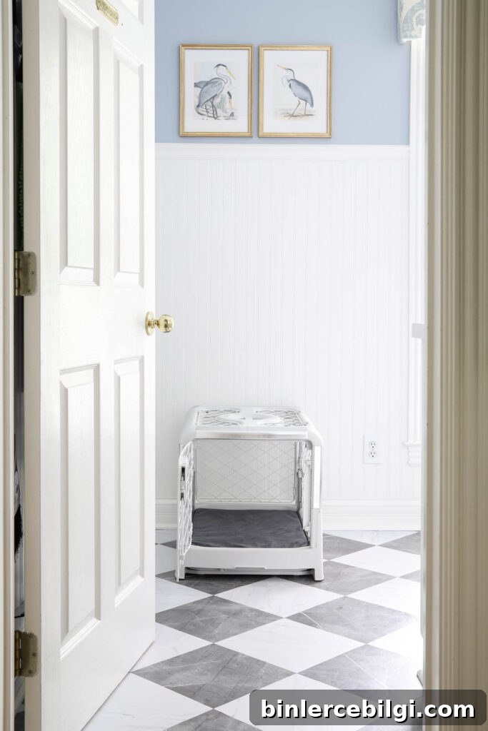 Revol Diggs dog crate in white with a gray pad cover in a laundry room.