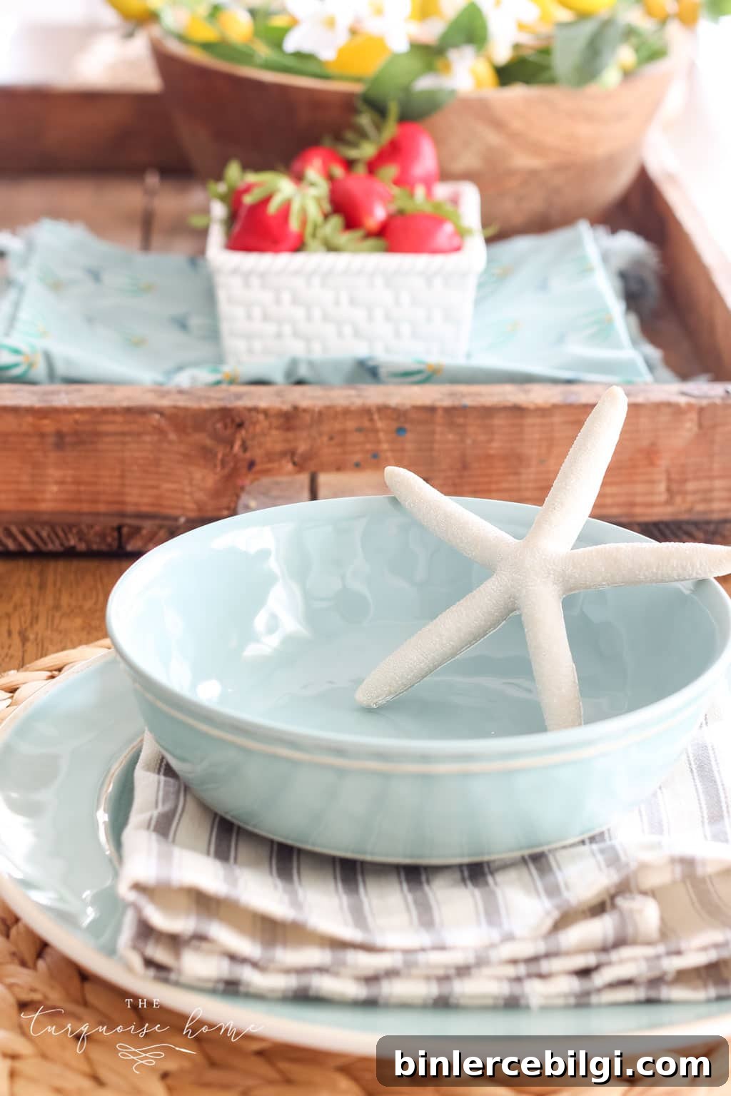 Summer Tablescape Ideas for Al Fresco Entertaining 6 Simple summer place setting with blue bowls and white starfish decor.