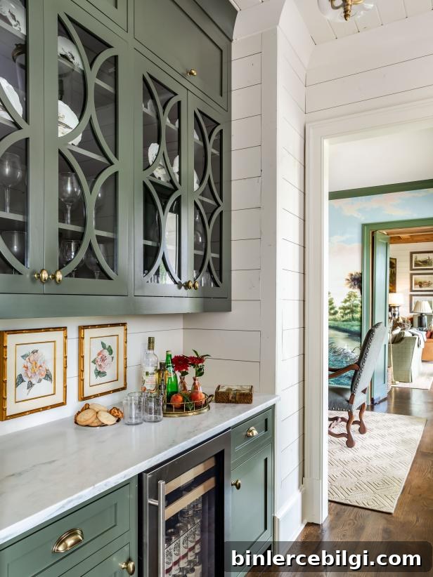 Green cabinets in a butler's pantry with white shiplap walls.