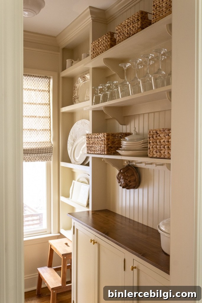 Creamy butler's pantry with wood countertops and peg rail.