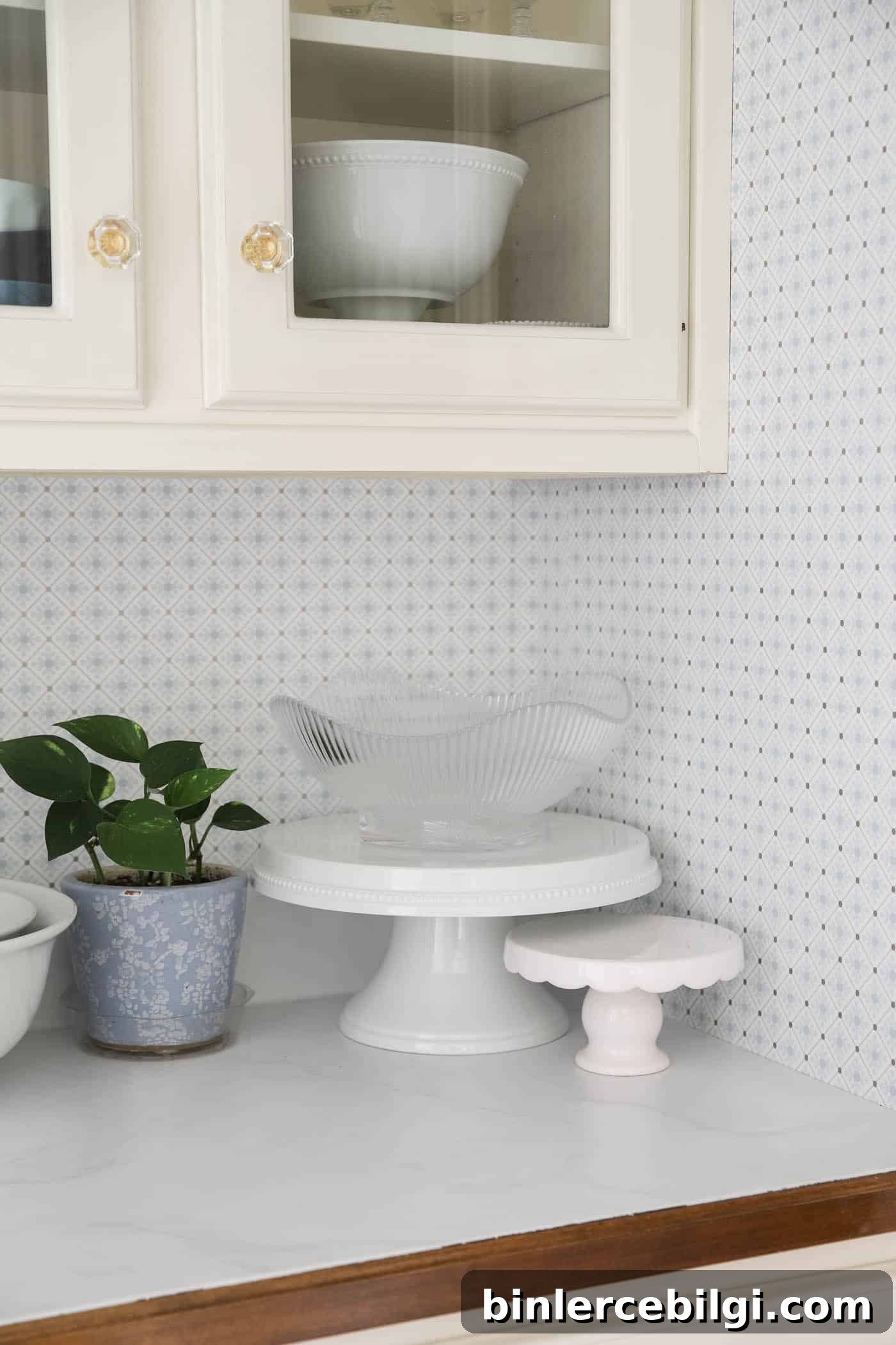 marble countertops with blue and white geometric wallpaper on the walls.