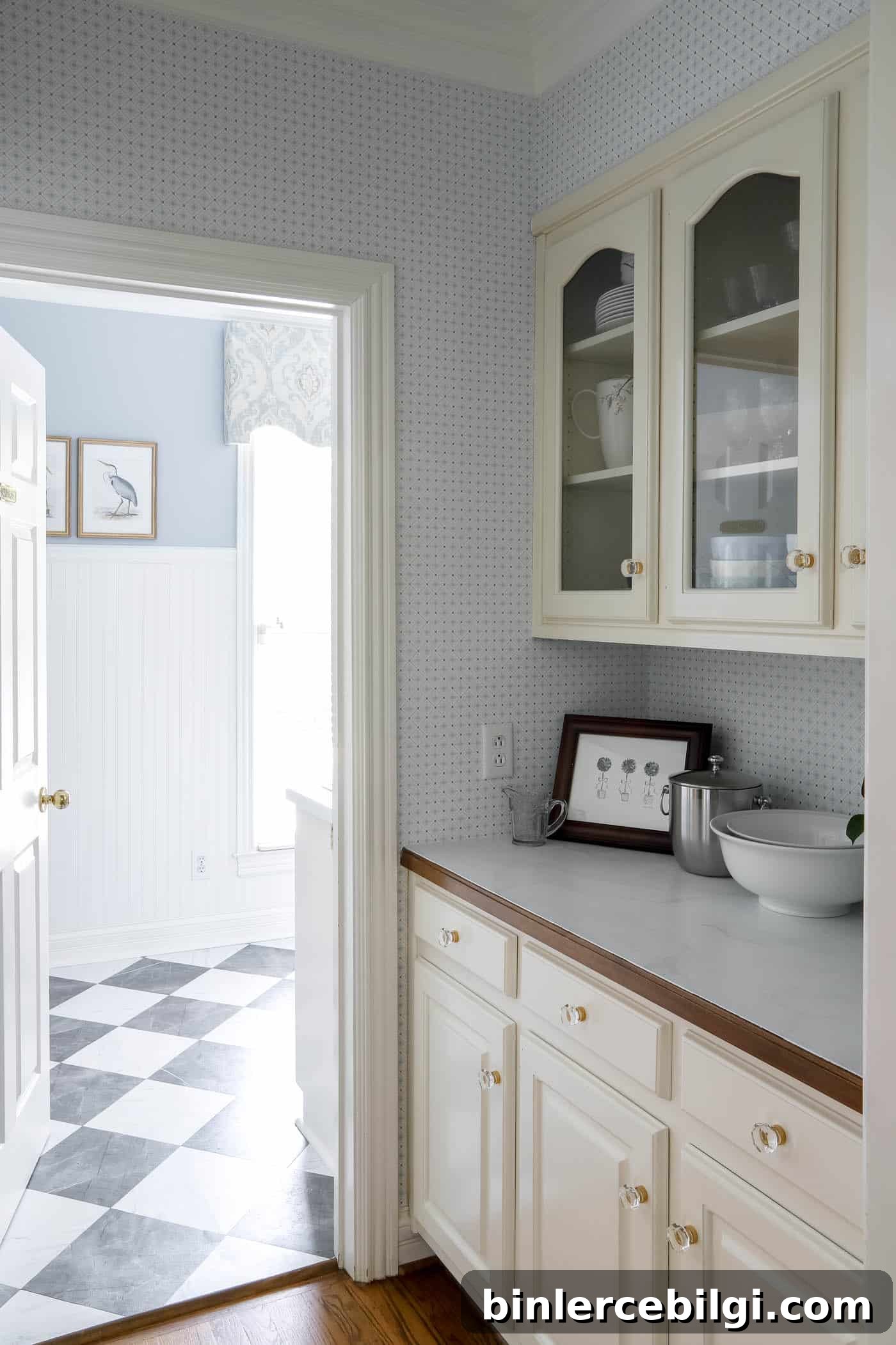 butler's pantry with blue and white wallpaper walking into a blue and white laundry room.