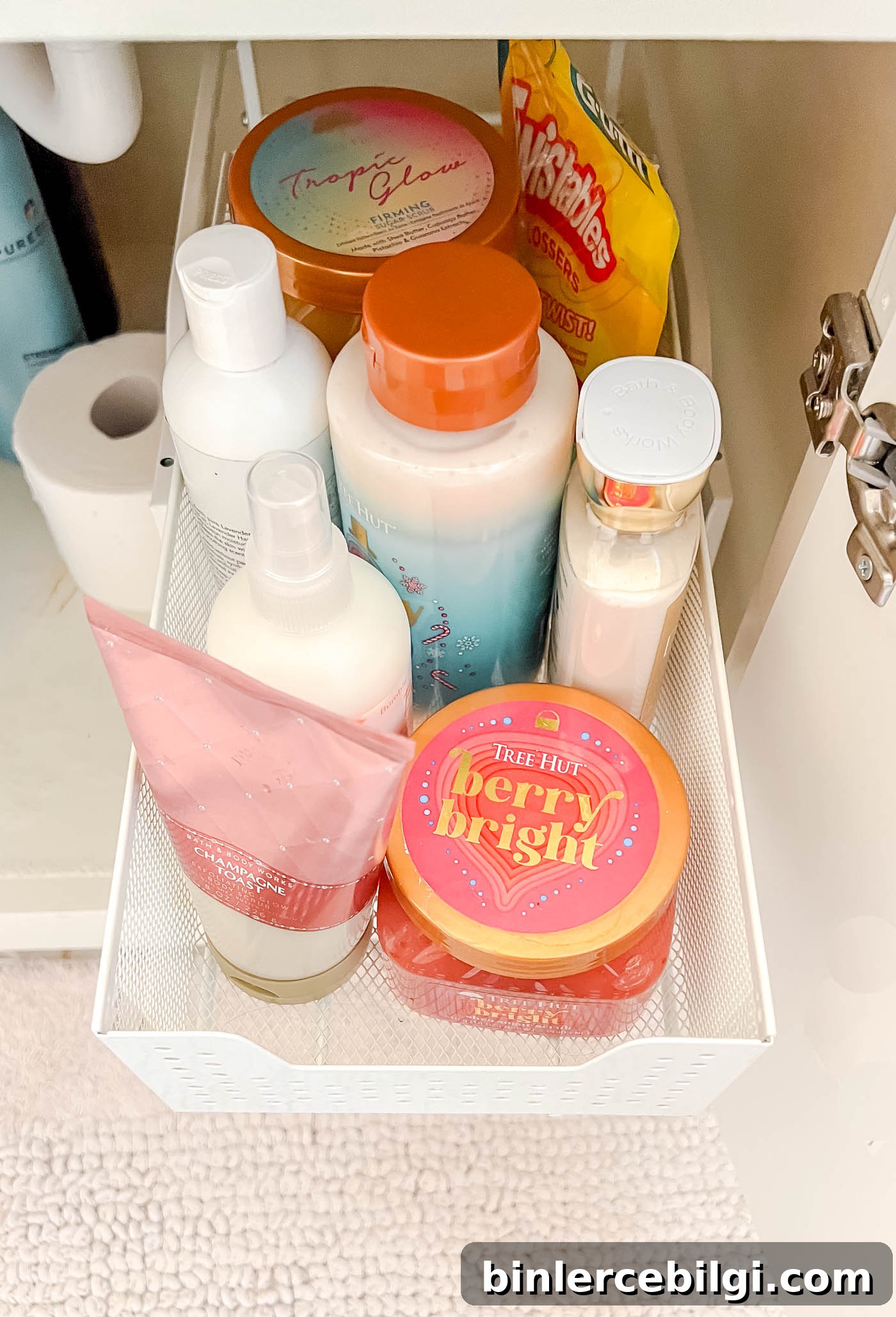 lotions and other Beaty products in bottles in a sliding drawer organizer