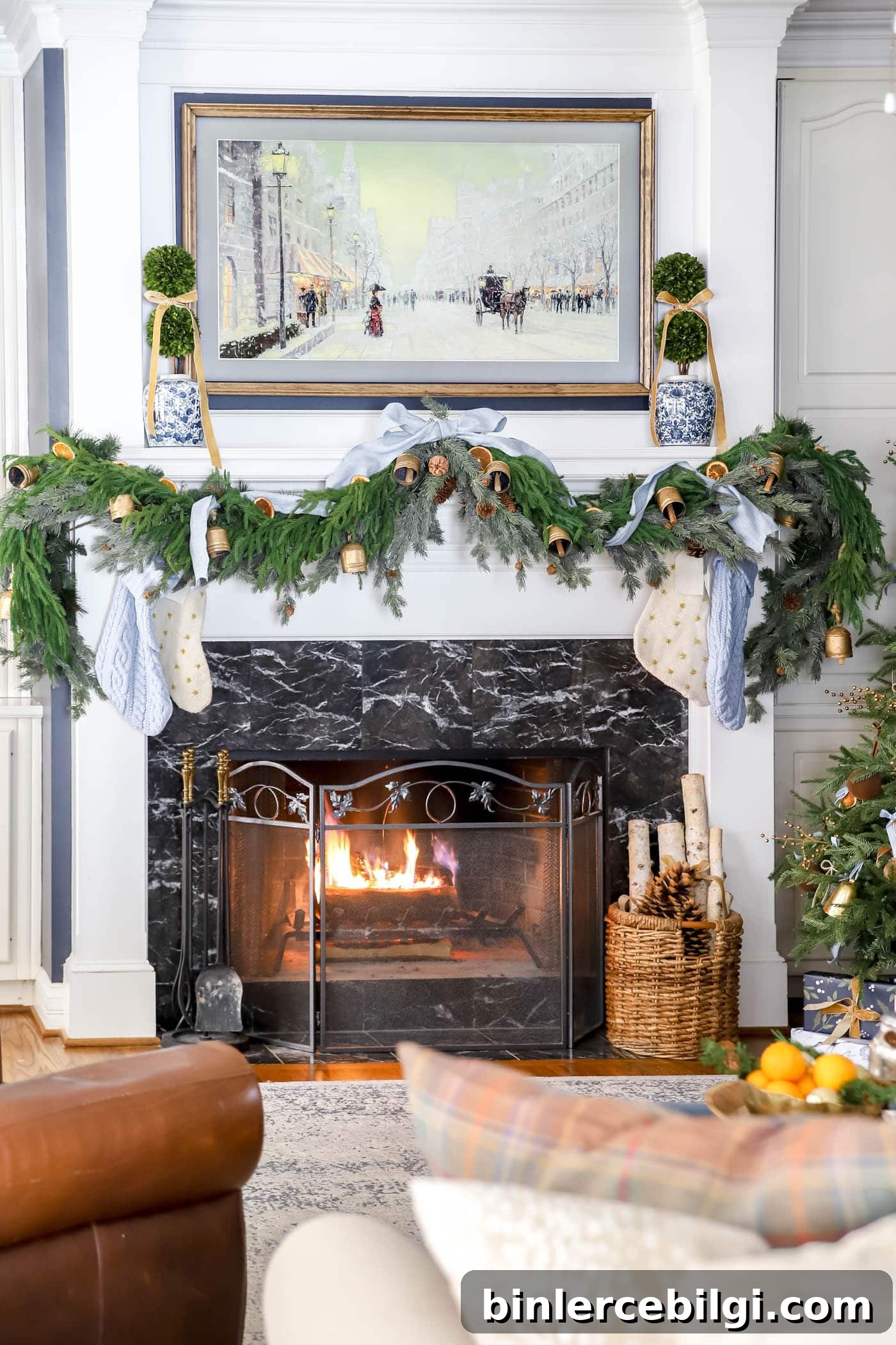 Christmas mantel with blue and orange decor.