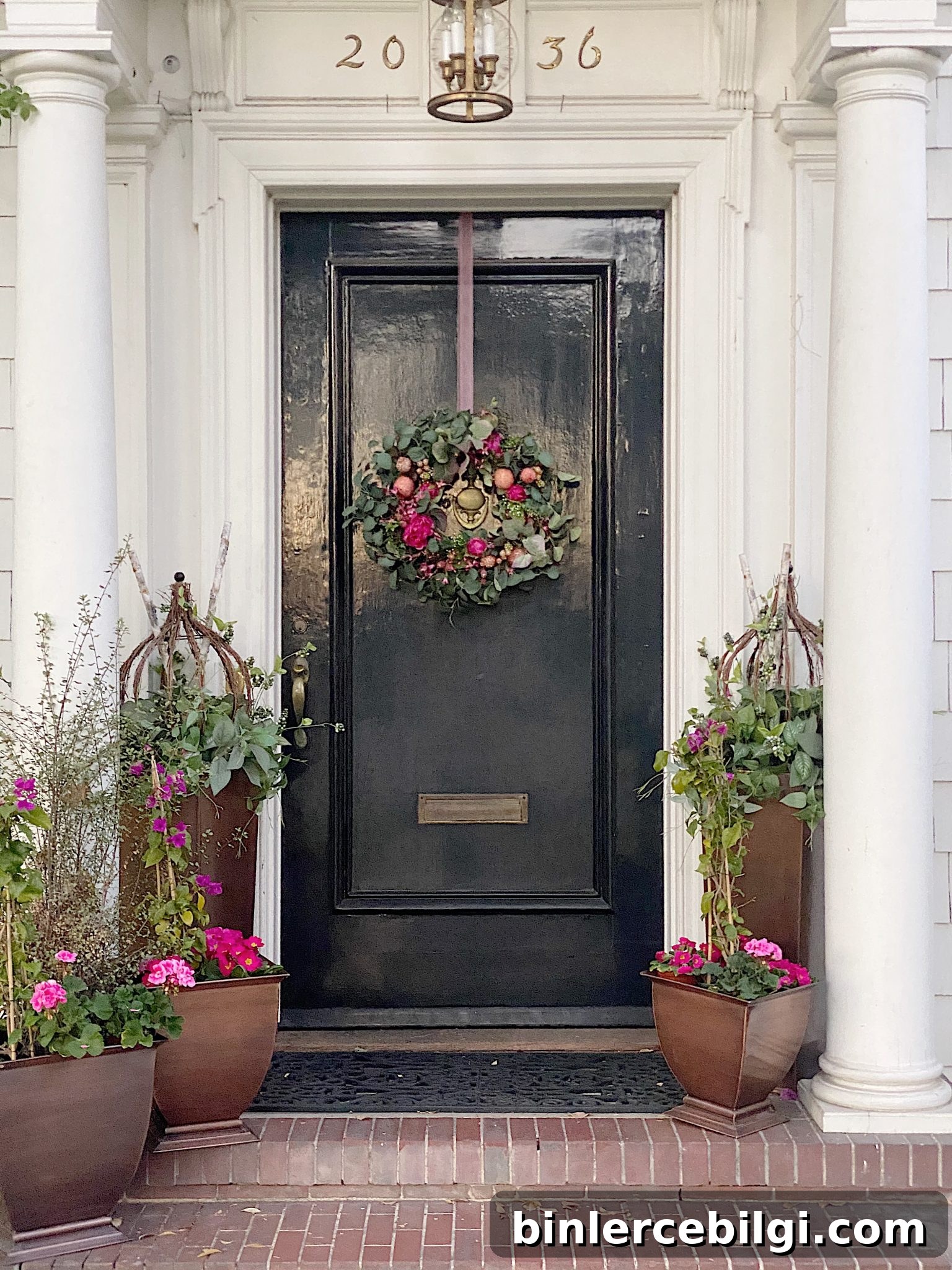 small front stoop with lots of flowers and greenery