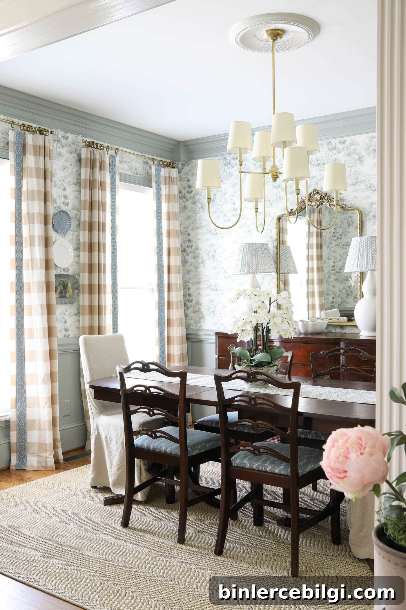 plates on a wall between windows in a formal traditional dining room.
