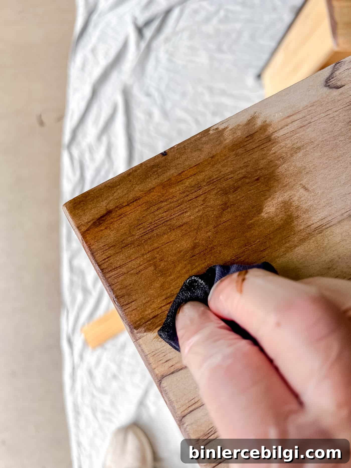 Refinish Wood Furniture: Step-by-Step DIY Guide 15 applying stain to a piece of wood furniture.