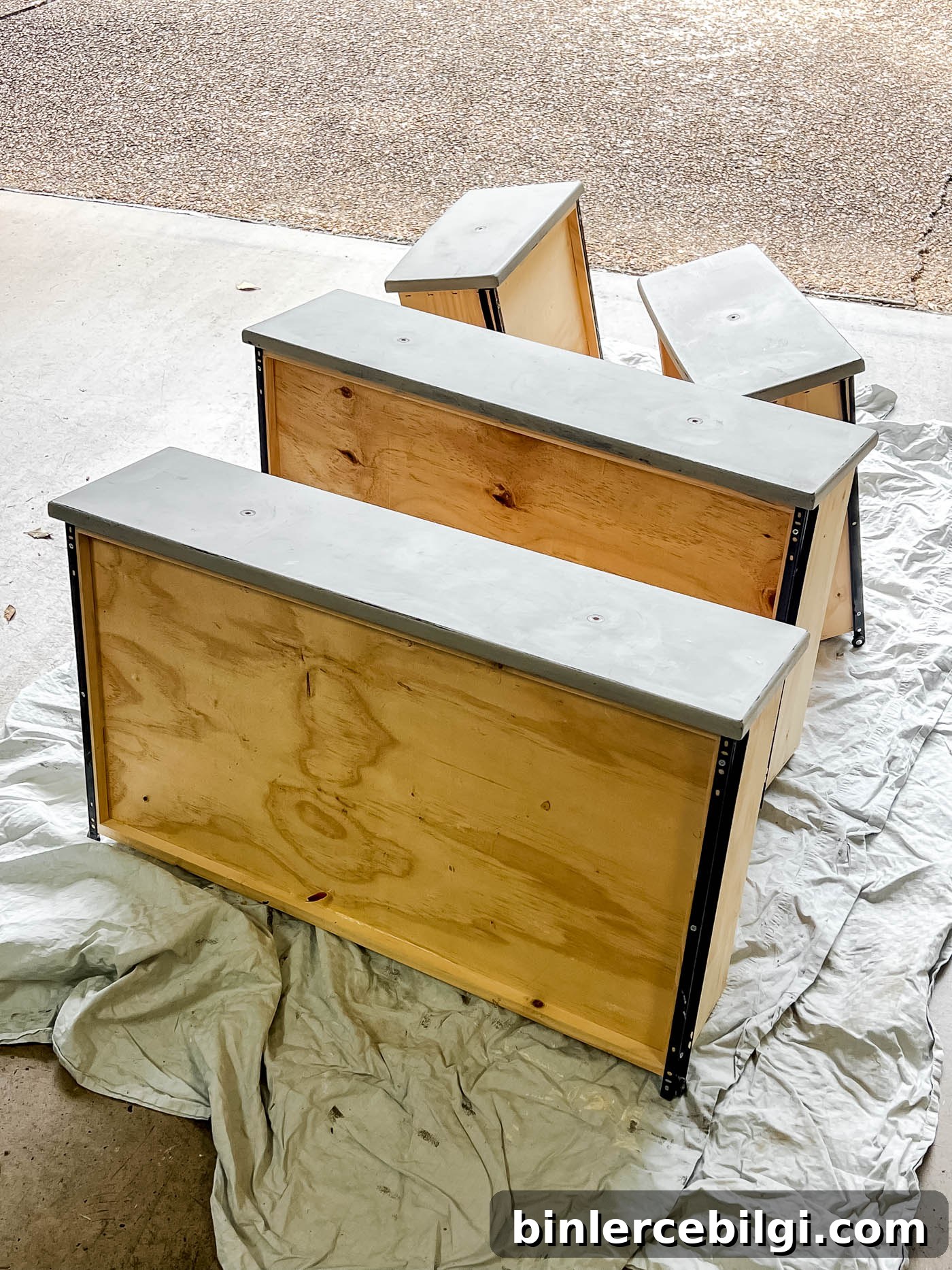 Refinish Wood Furniture: Step-by-Step DIY Guide 7 Drawers removed from dresser in the garage floor.