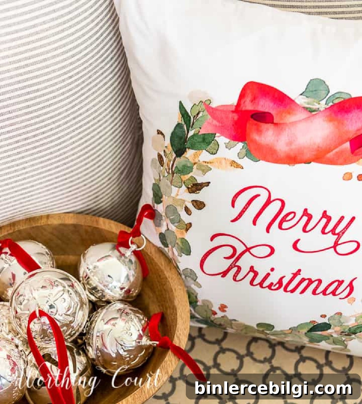 christmas ornaments in a bowl next to a christmas pillow.