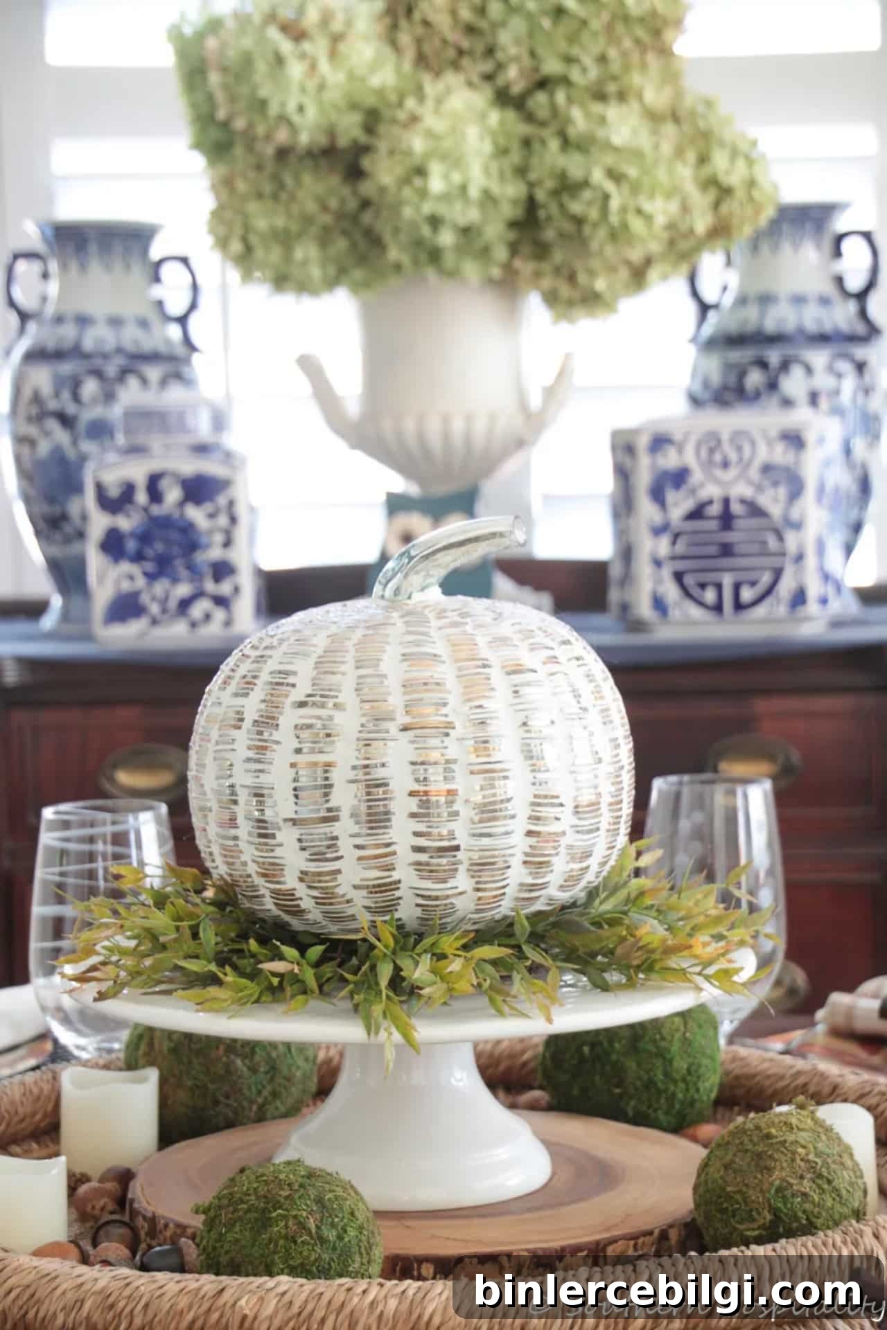 Thanksgiving table with pumpkin decor in the middle.