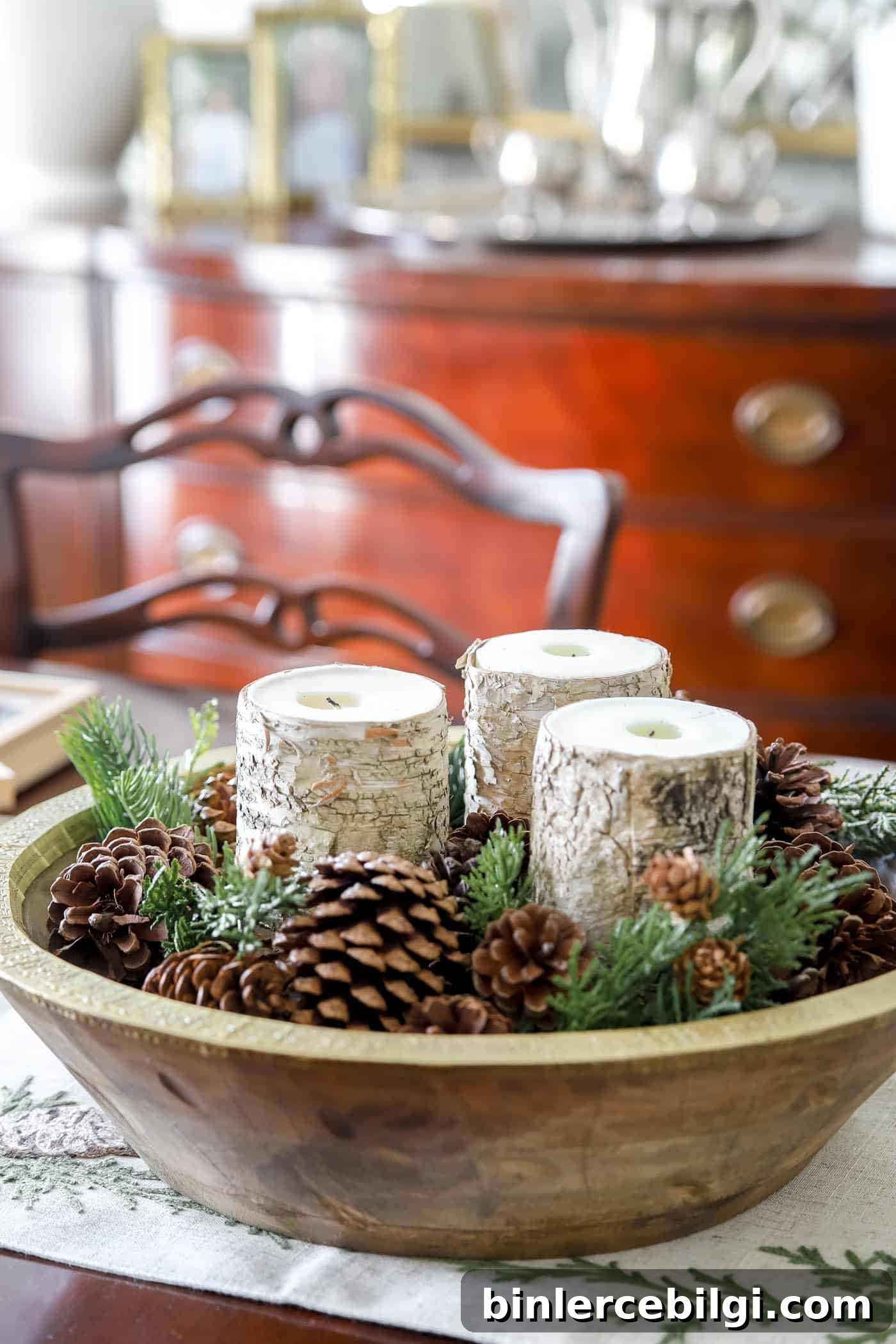Post-Christmas Winter Decor Ideas to Cozy Up Your Home 5 winter pinecones and pops of greenery in a large bowl with candles.