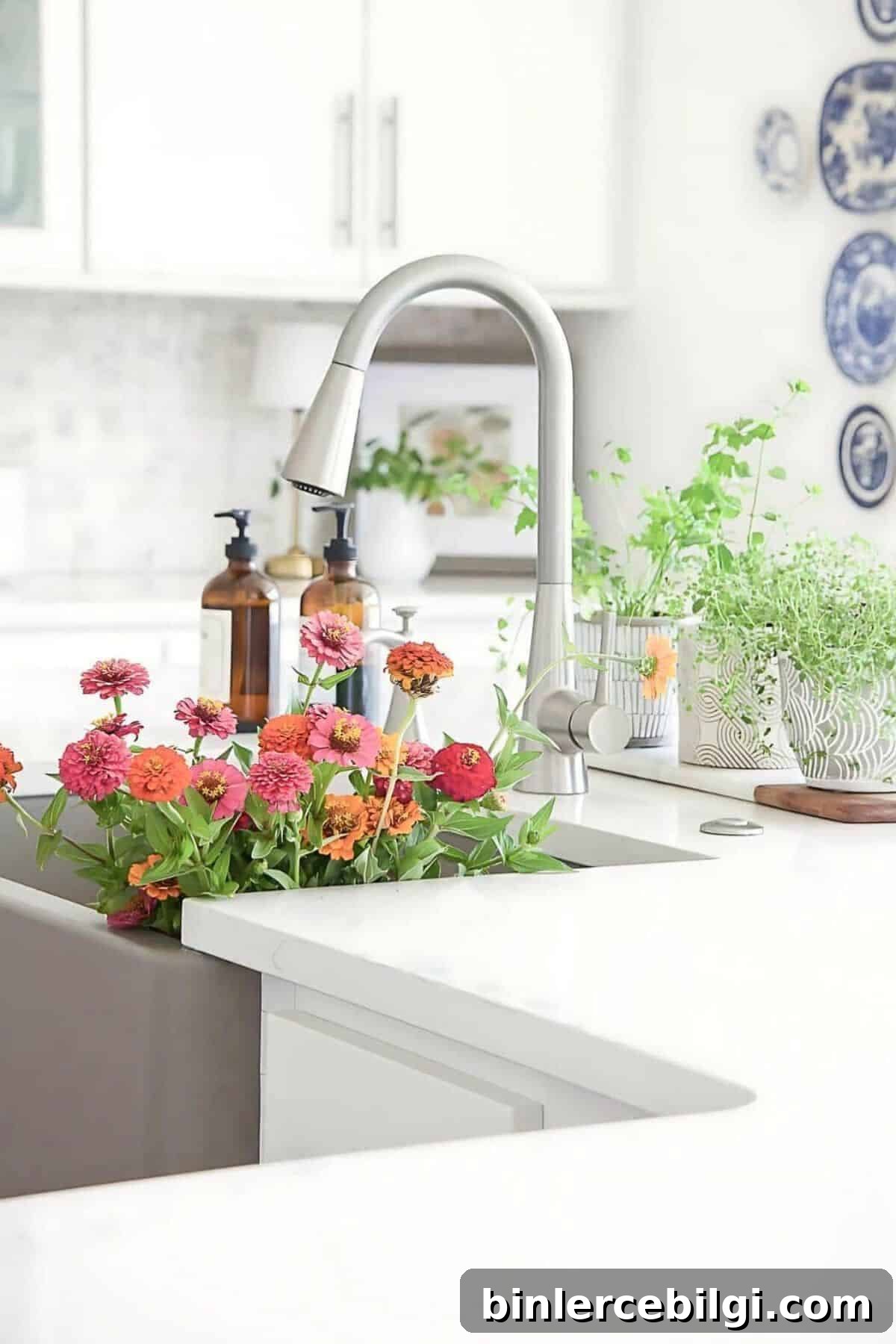 Bright white kitchen with farmhouse sink, modern faucet, fresh flowers and countertop herb garden
