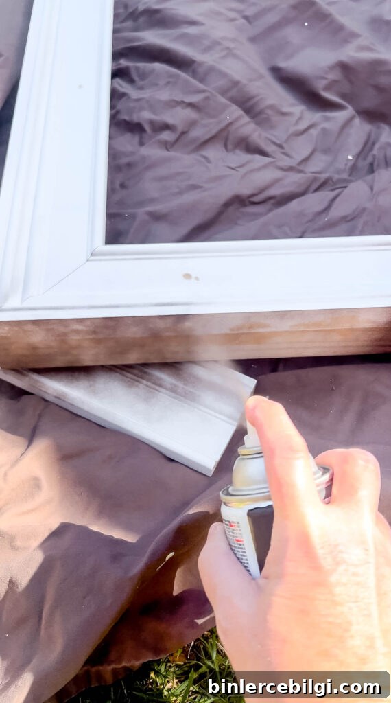 Spray painting the frame a dark brown color.