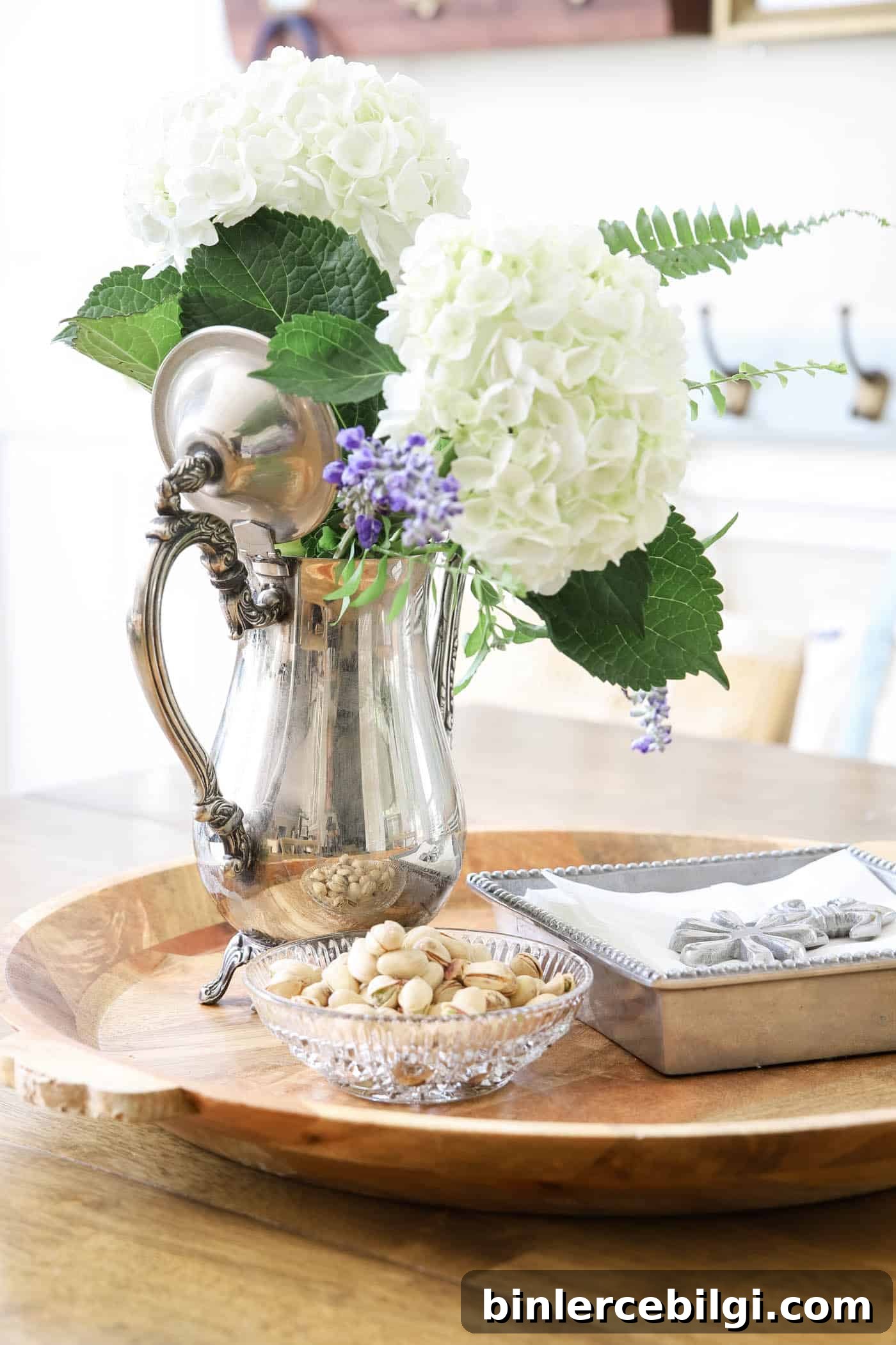 silver coffee pot as a flower vase on a kitchen table. 