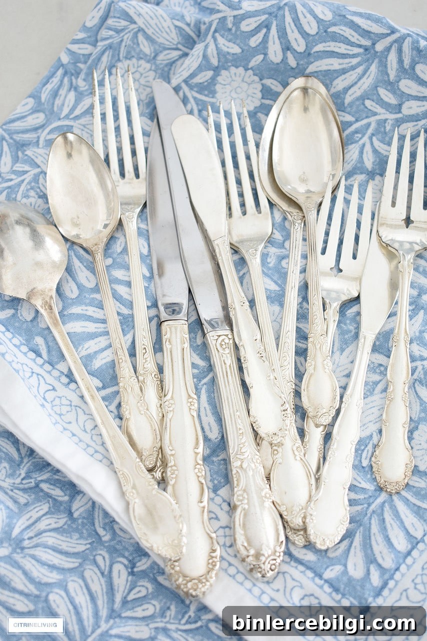 silver utensils on a blue and white napkin
