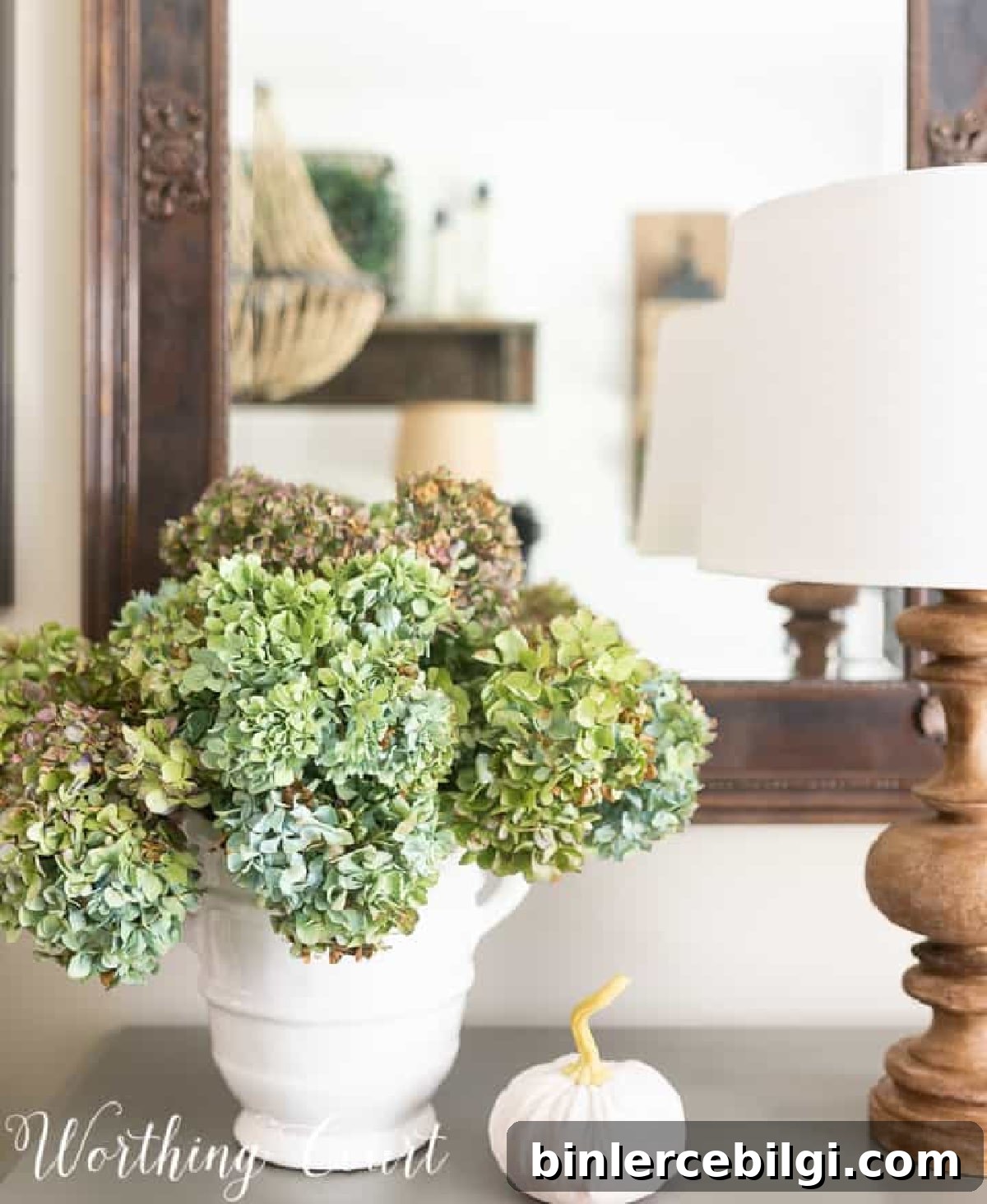 fall pumpkin and blue and green hydrangeas with a wooden lamp